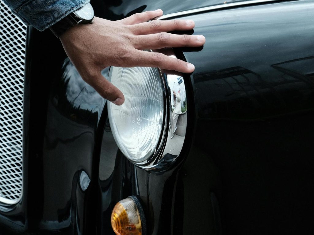 A mechanic reviewing a used car mileage gauge, offering check used car service Houston.