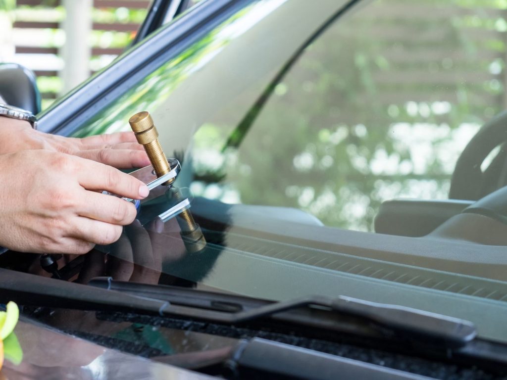 A mechanic examining a used car dashboard, offering check used car service Houston.