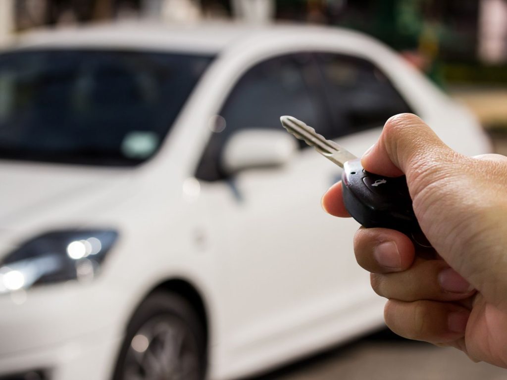 A mechanic inspecting a used car odometer, offering check used car service Houston.