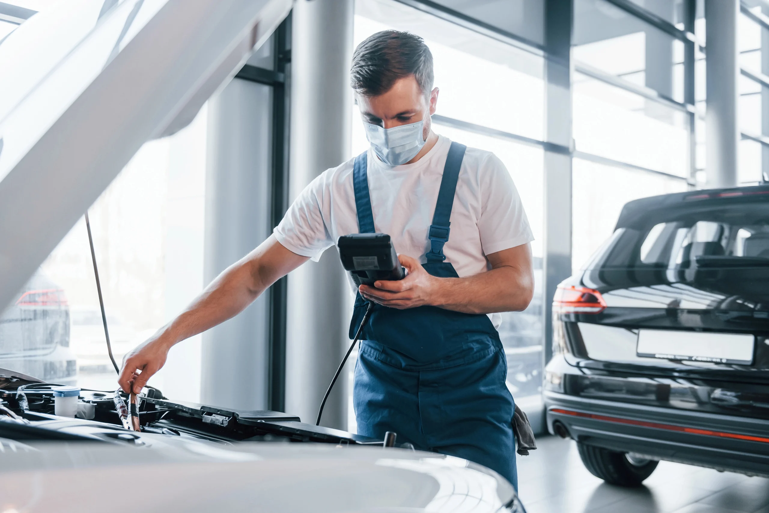 Technician performing a Tesla certified pre purchase inspection Houston and reviewing key vehicle systems during the evaluation.