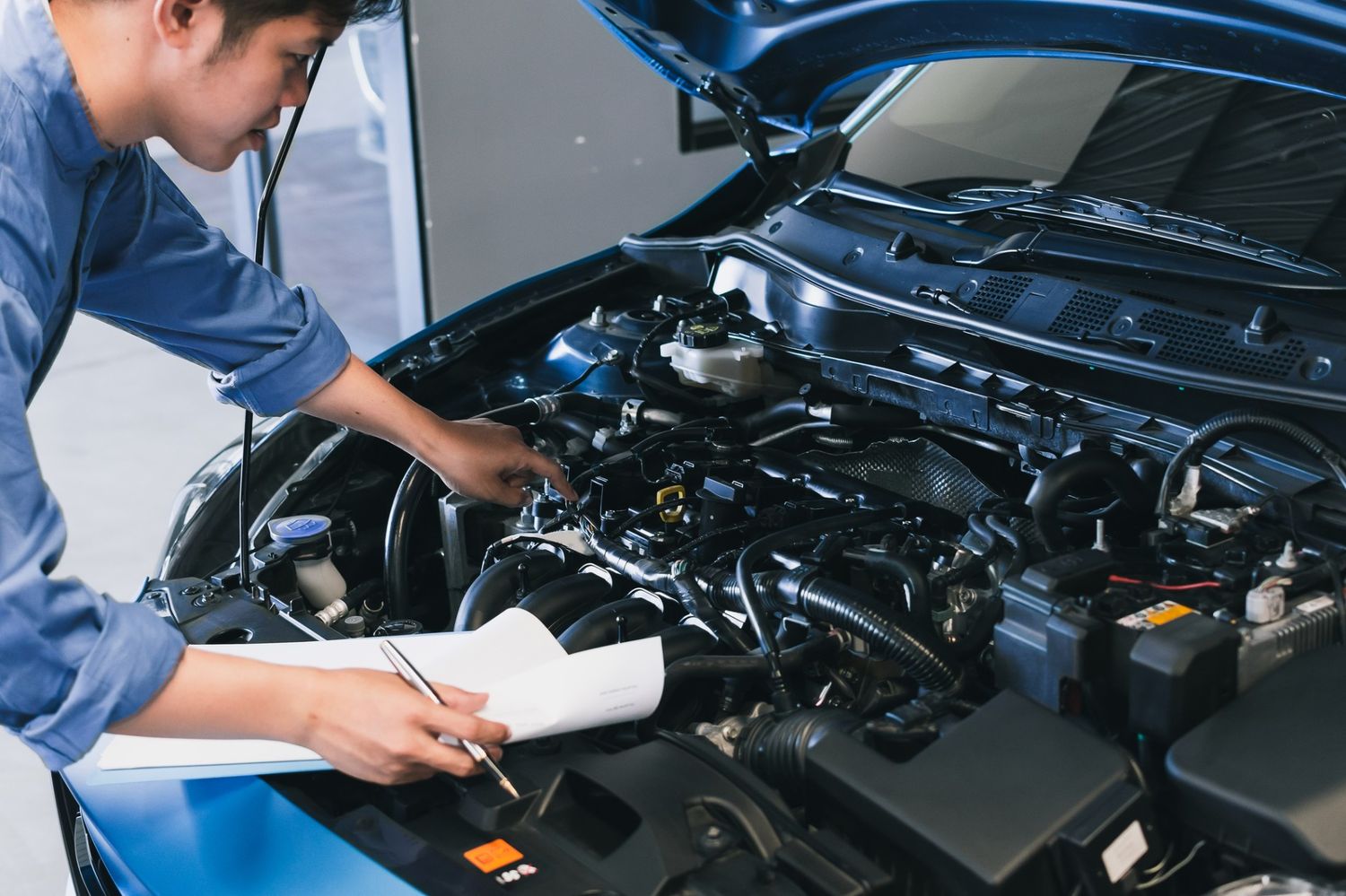 Car buyers inspection Houston — certified mechanic documenting findings during pre purchase vehicle check