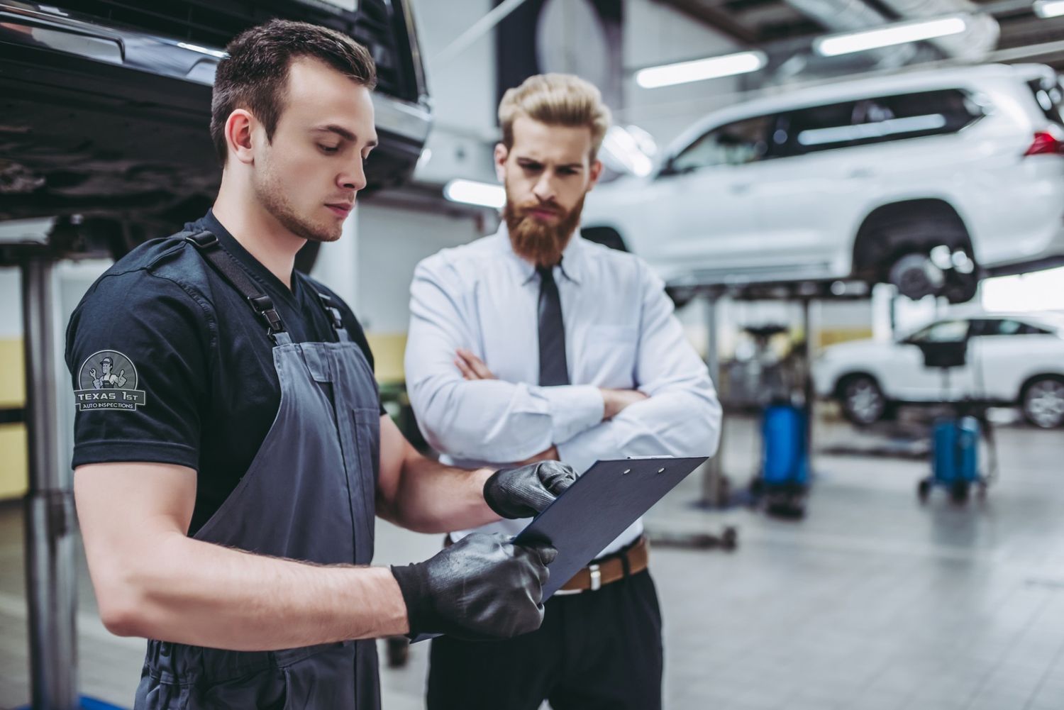 A professional mechanic from Texas 1st Auto Inspections reviewing a diagnostic report with a client during a car buyers inspection in Houston.